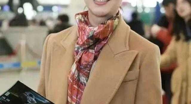 左小青携女儿走机场,穿驼色大衣配牛仔裤好减龄,彩色围巾显气质